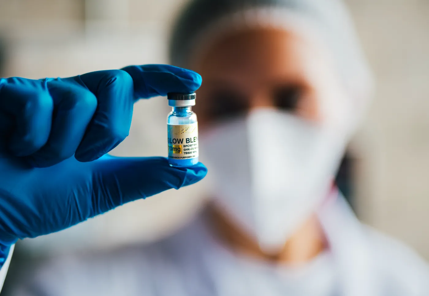 Lab technician holding a research peptide vial